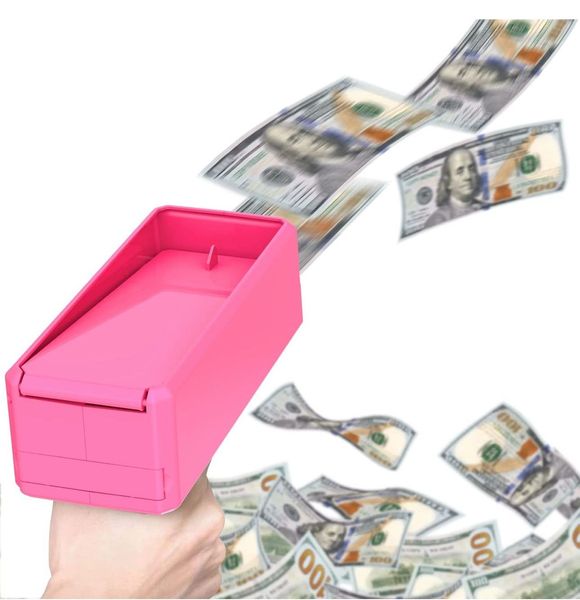 A hand holding a pink box with money falling out of it