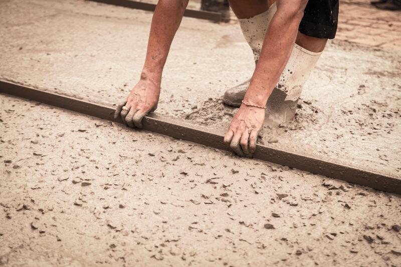 worker building concrete walkway