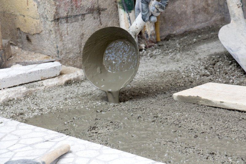 worker pouring out concrete in orange county
