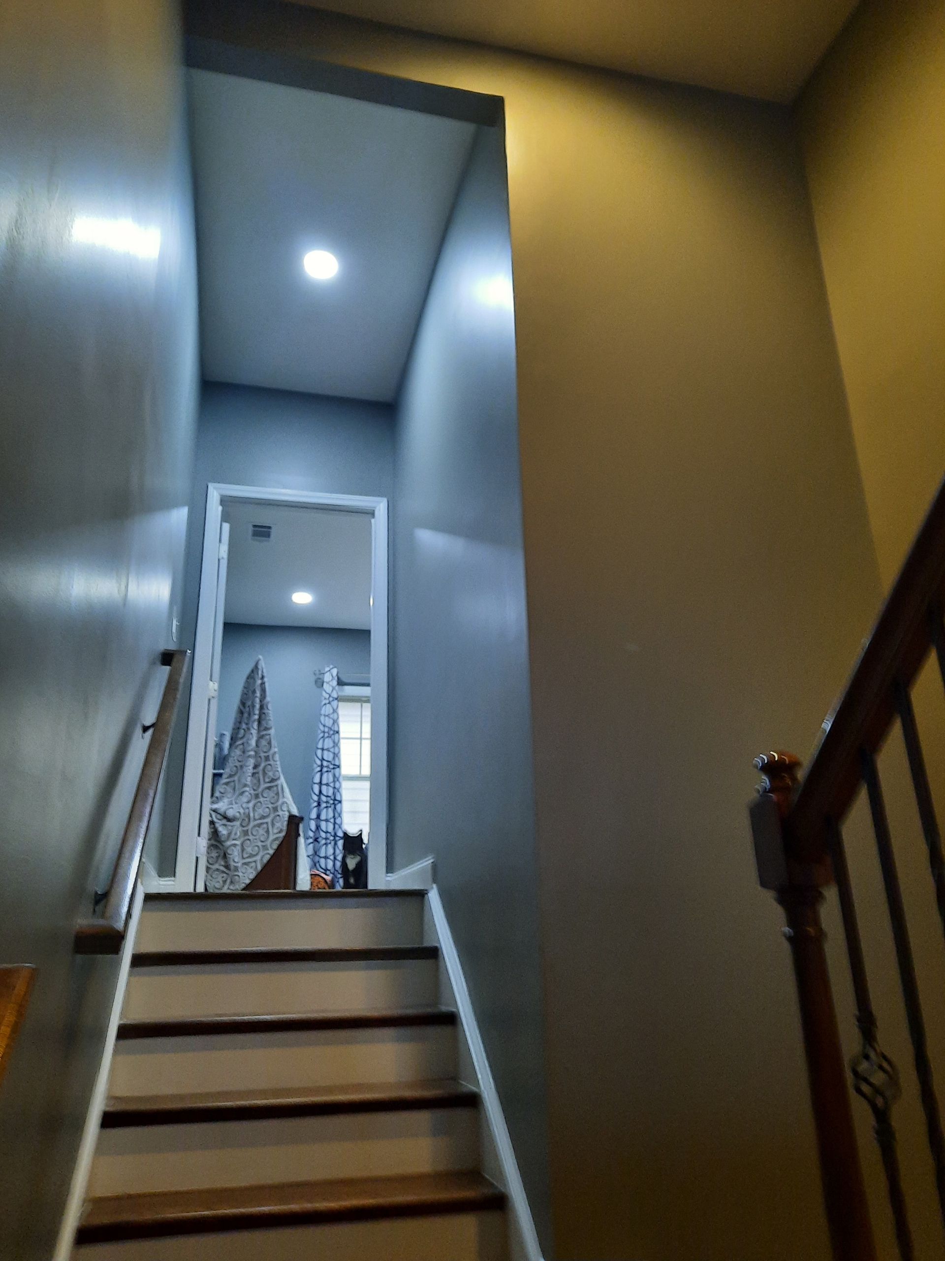 A staircase leading up to a room with a door