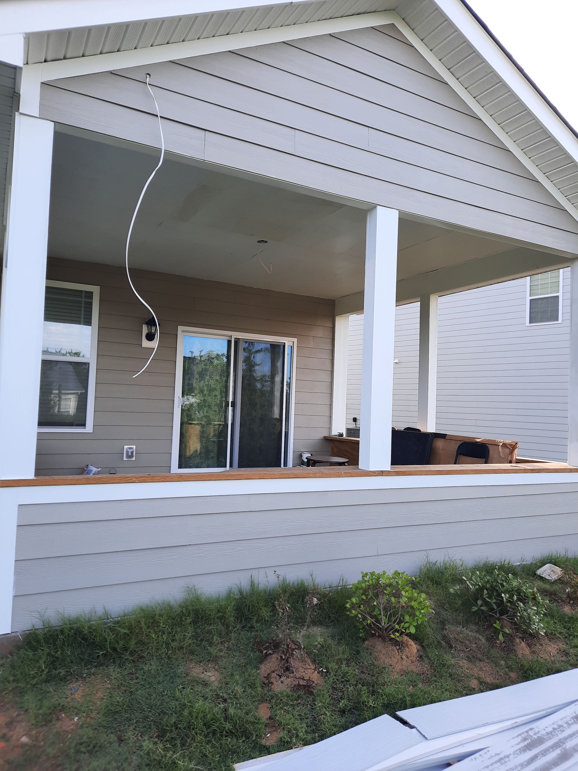 A house with a porch and a sliding glass door
