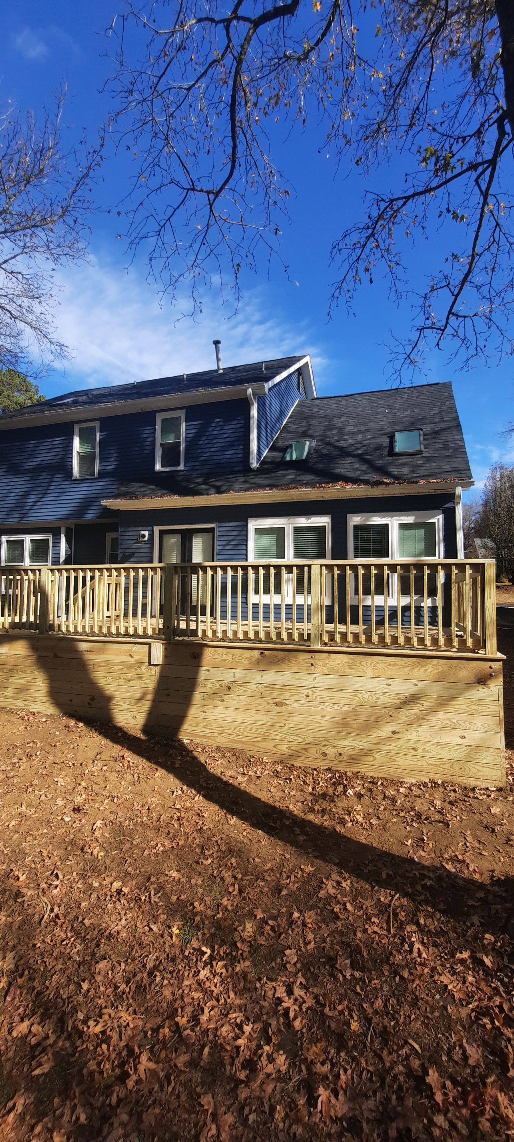 A large house with a large deck in front of it.