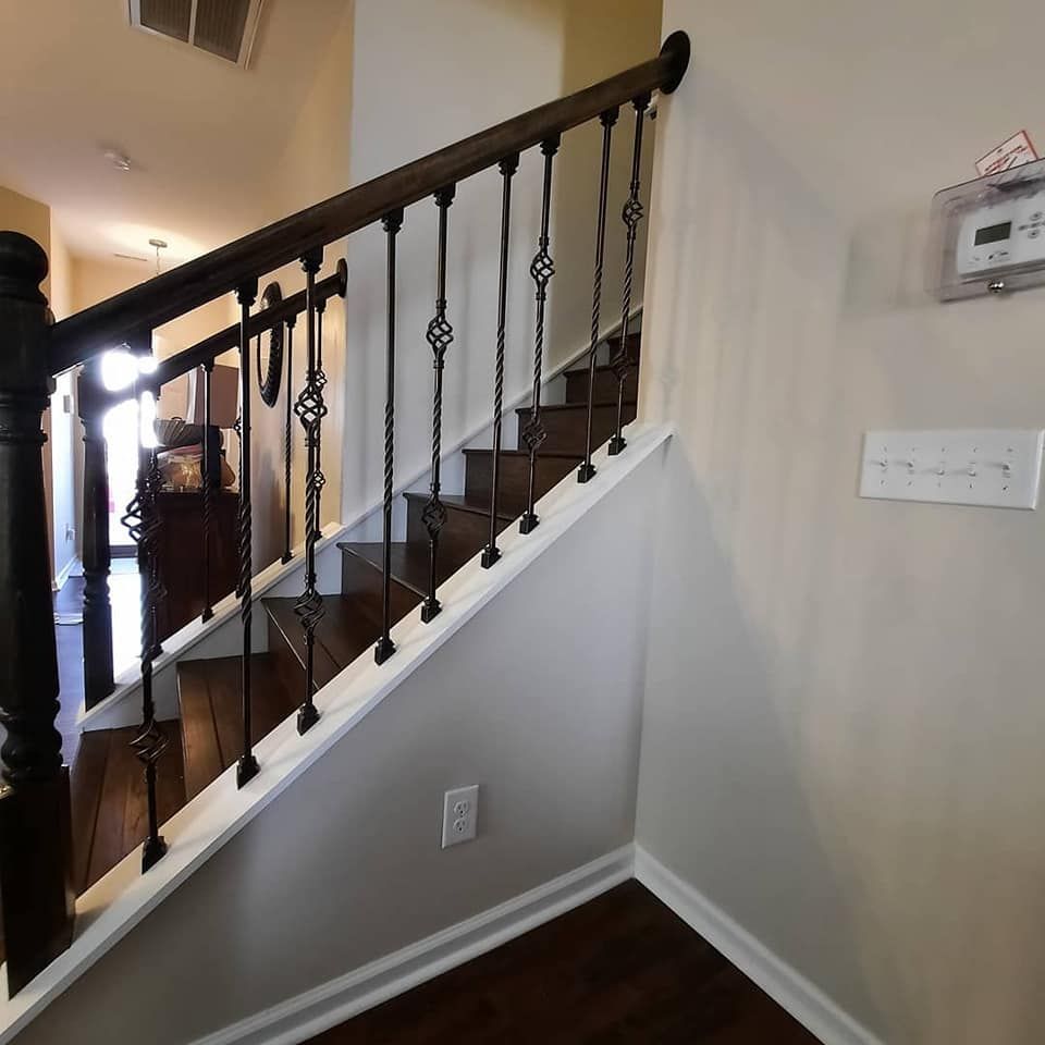 A staircase with a wrought iron railing in a house