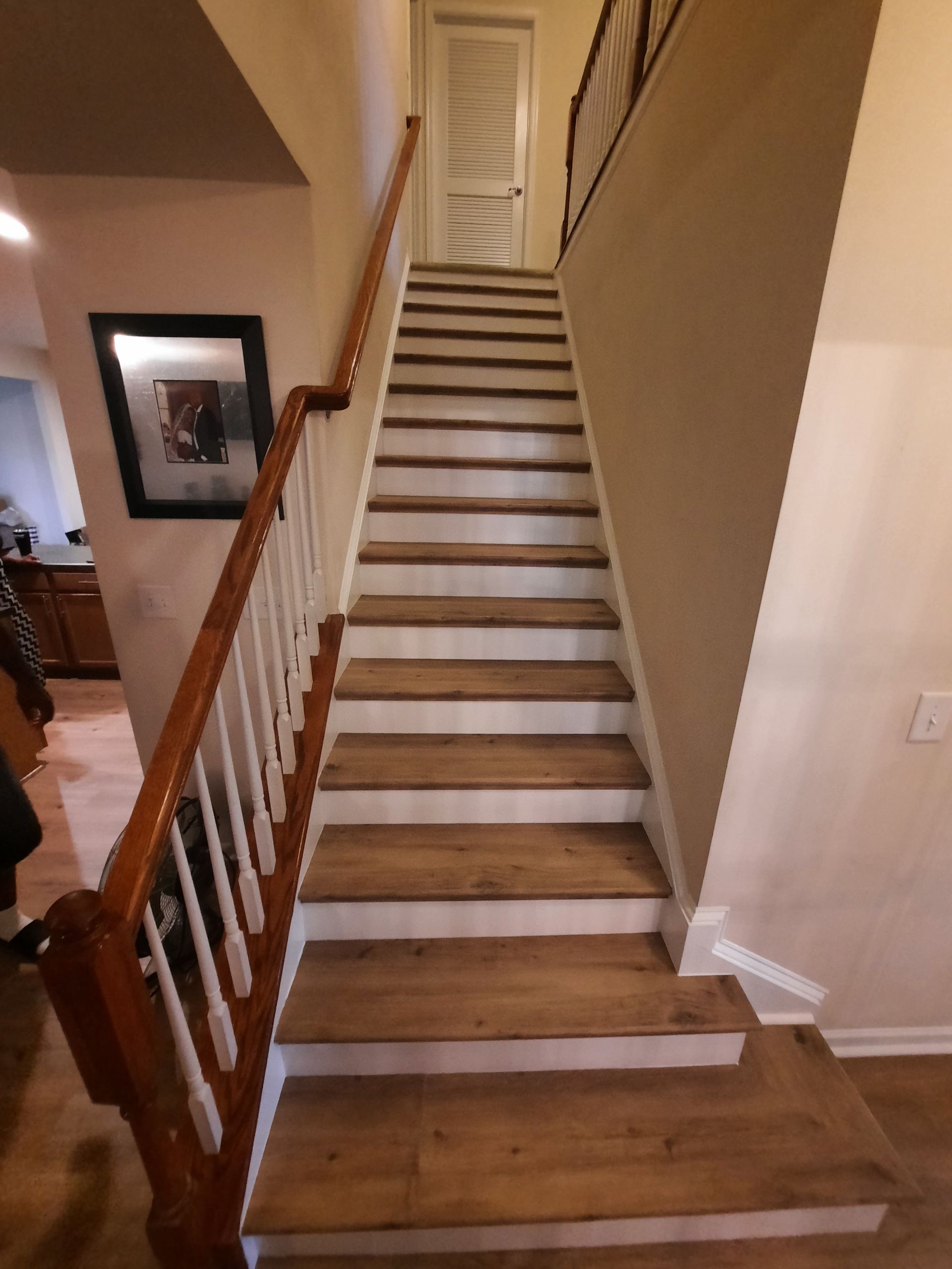 A staircase with wooden steps and a white railing