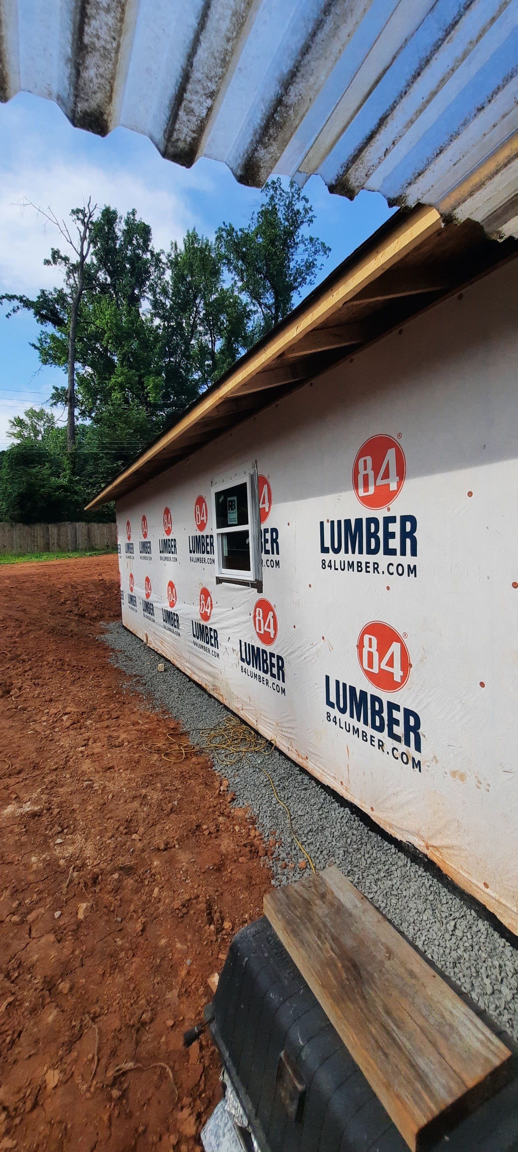 A building is being built with lumber on the side of it.