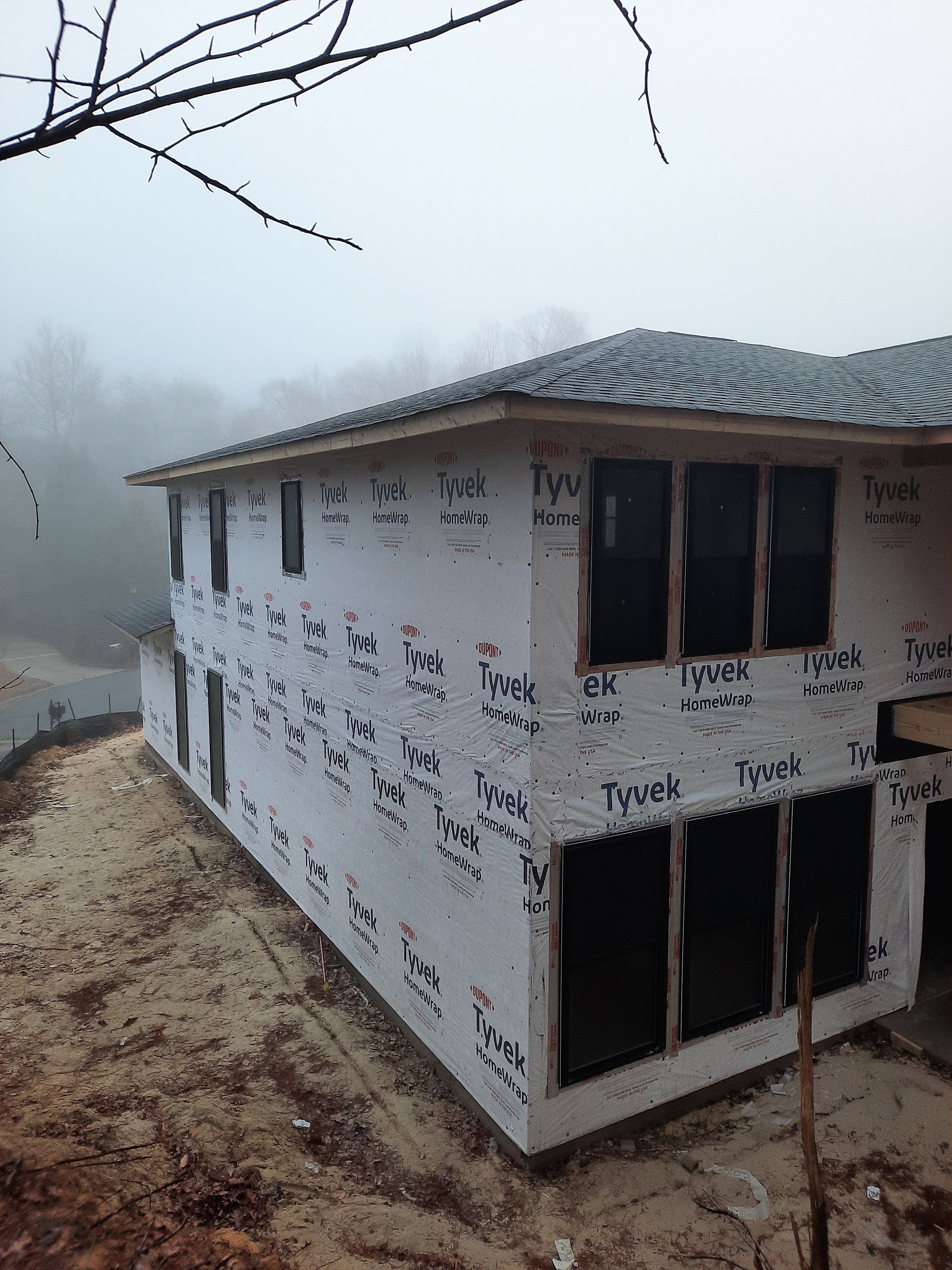 A house that is being built with a lot of windows