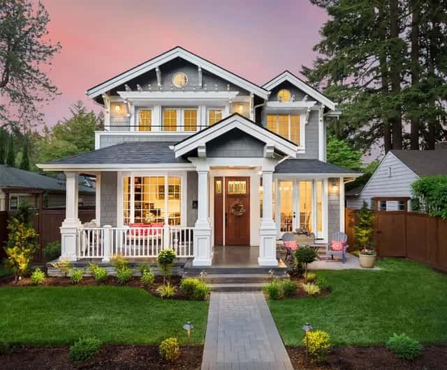 A large house with a large porch and a walkway leading to it.