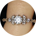 A woman is wearing a diamond ring on her finger.