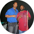 Two men are standing next to each other in a circle holding pool cues.