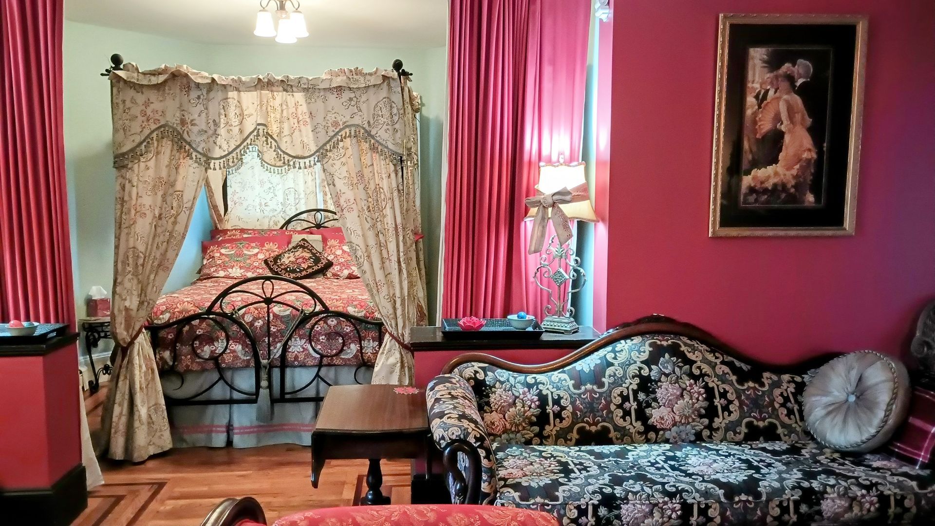 a bedroom with a canopy bed and a couch