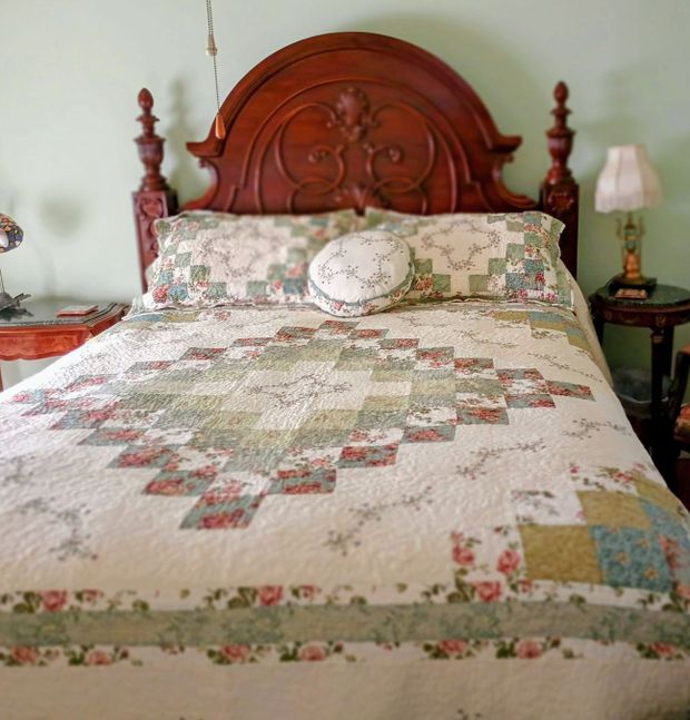 a bed with a quilt and pillows on it