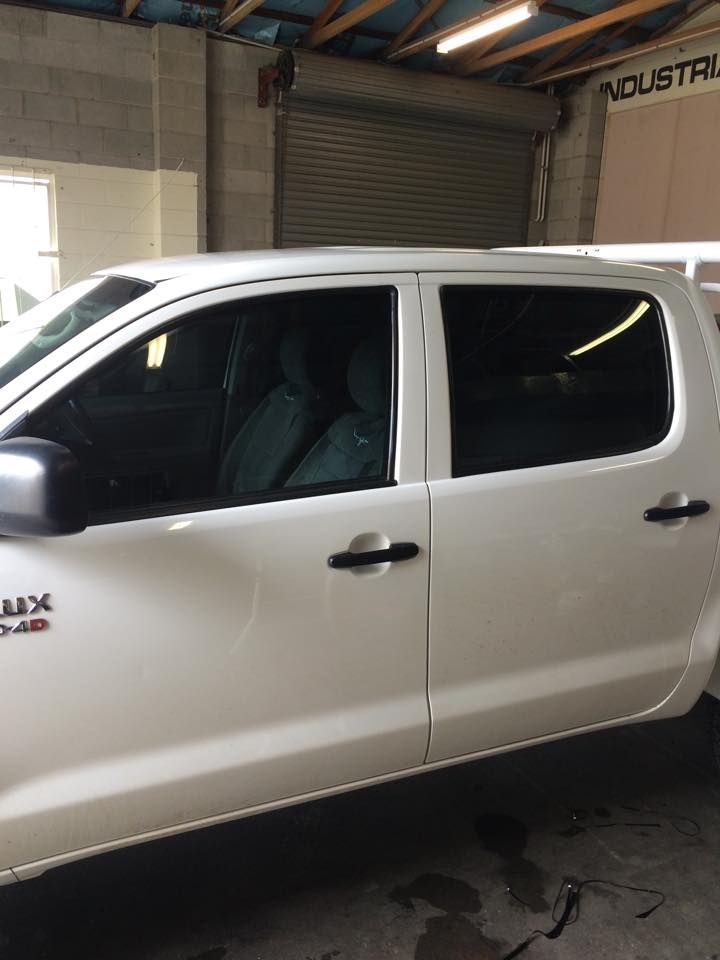 A White Pickup Truck Is Parked in A Garage — Epic Window Tinting in Sarina, QLD