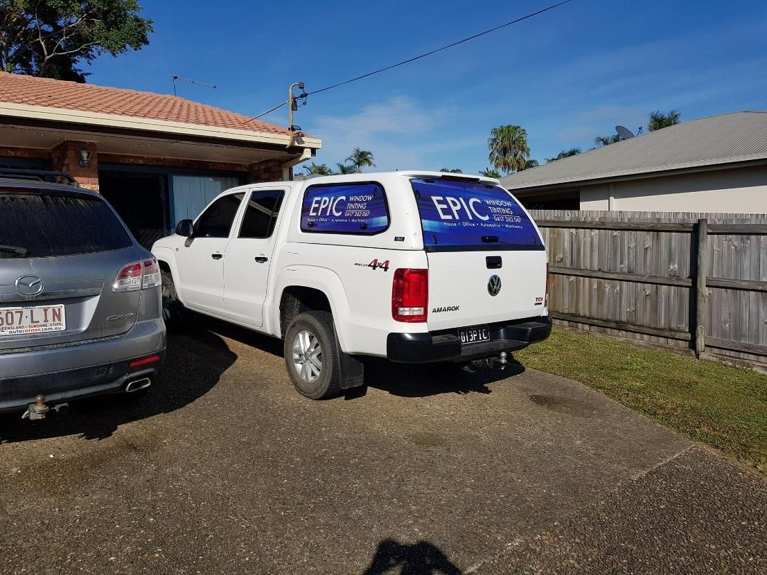 A White Truck with A Canopy Is Parked in Front of A House β Epic Window Tinting in Glenella, QLD