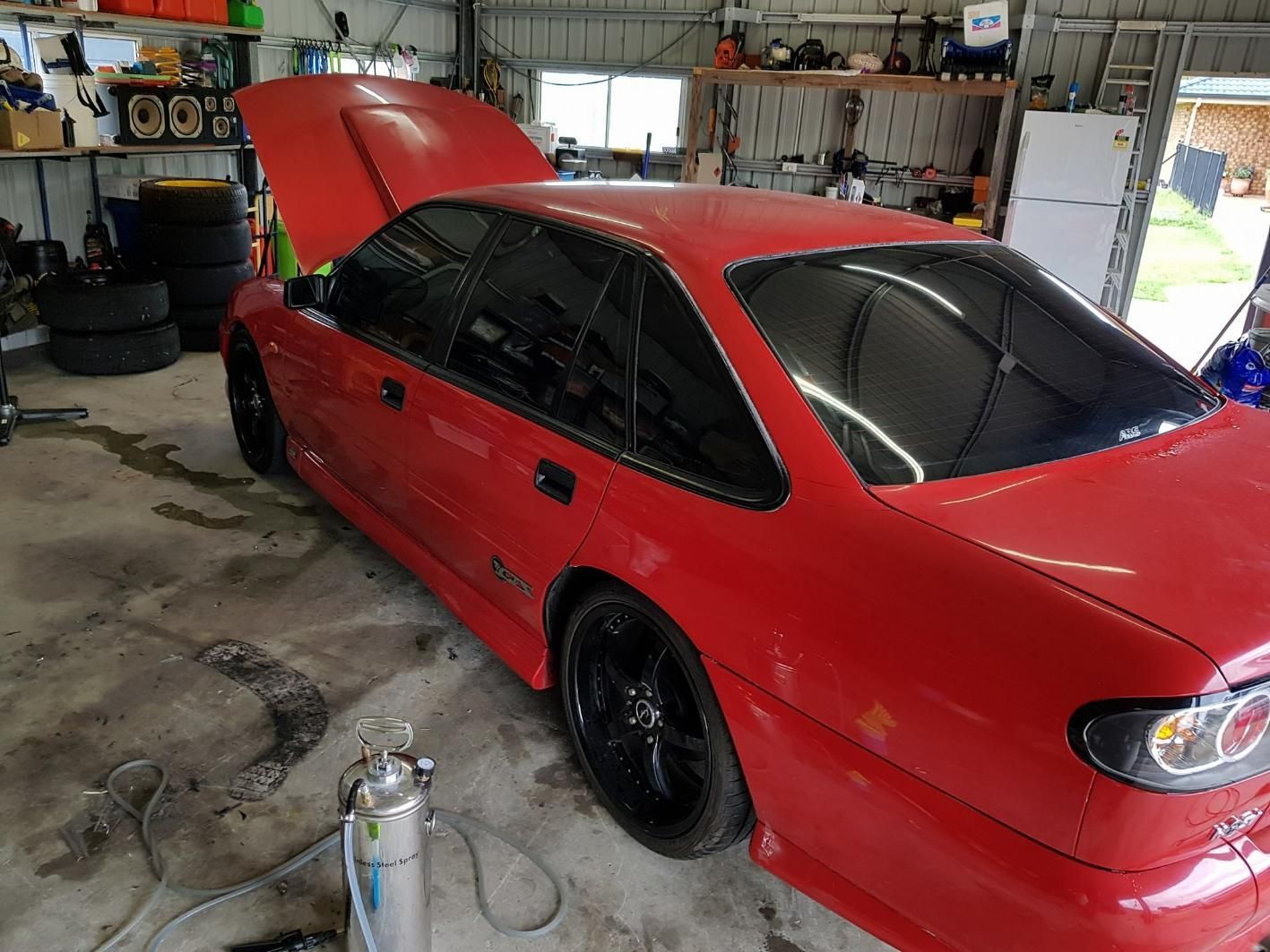 A Red Car with The Hood up Is Parked in A Garage β Epic Window Tinting in Glenella, QLD