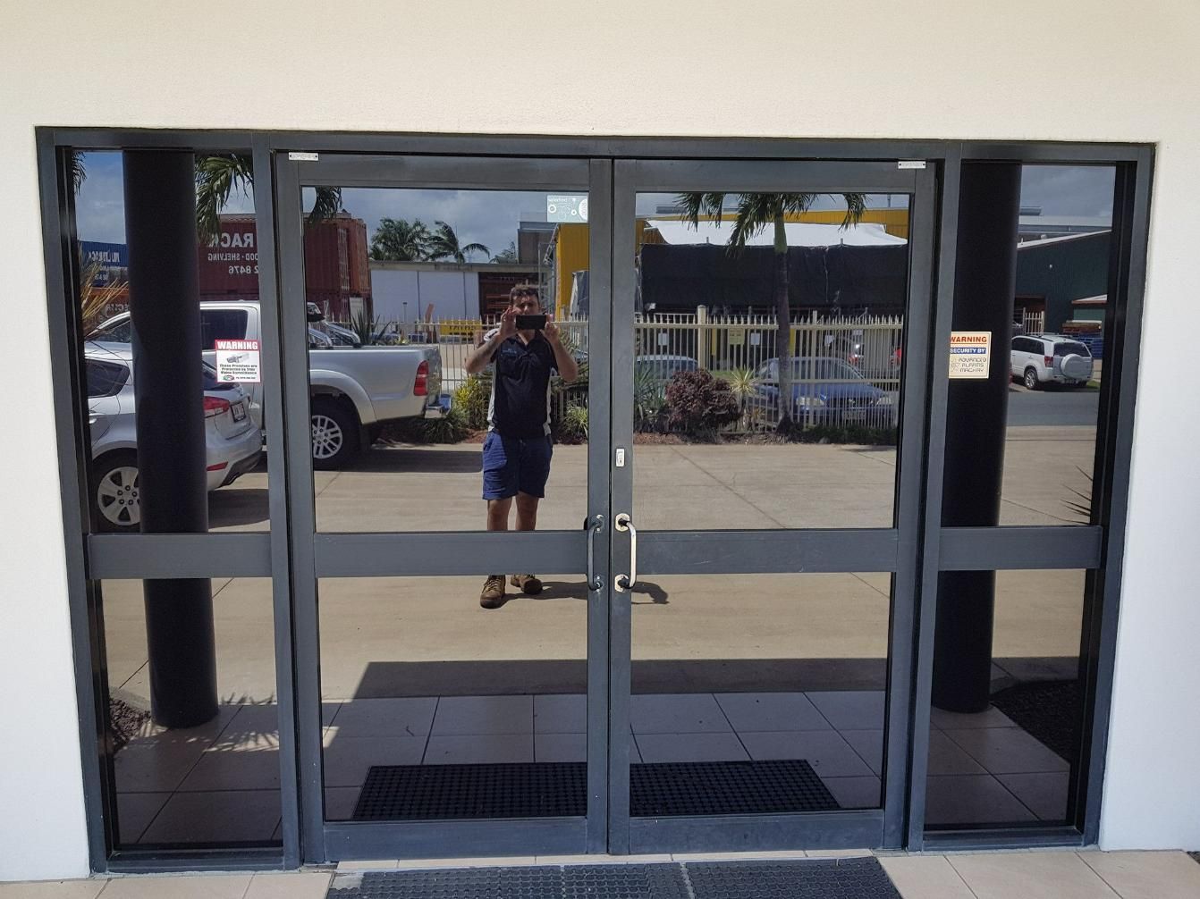 A Man Taking a Picture of Himself in A Doorway β Epic Window Tinting in Glenella, QLD