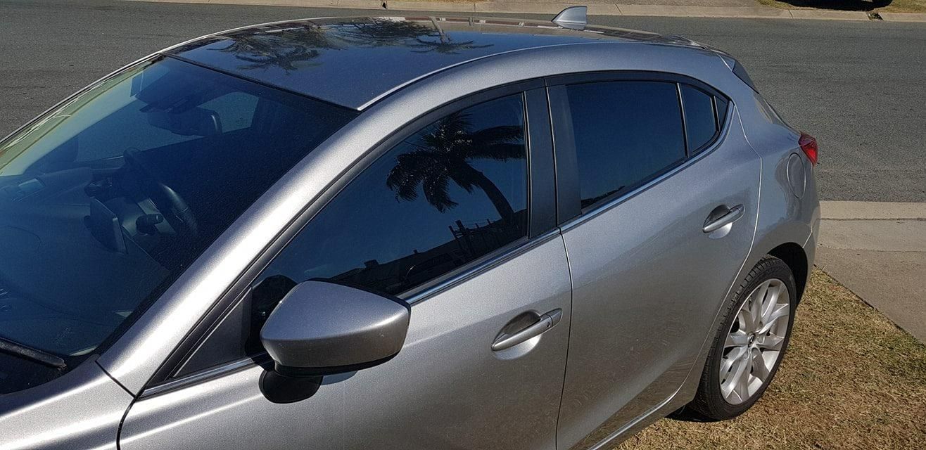 A Silver Car Is Parked on The Side of The Road β Epic Window Tinting in Glenella, QLD