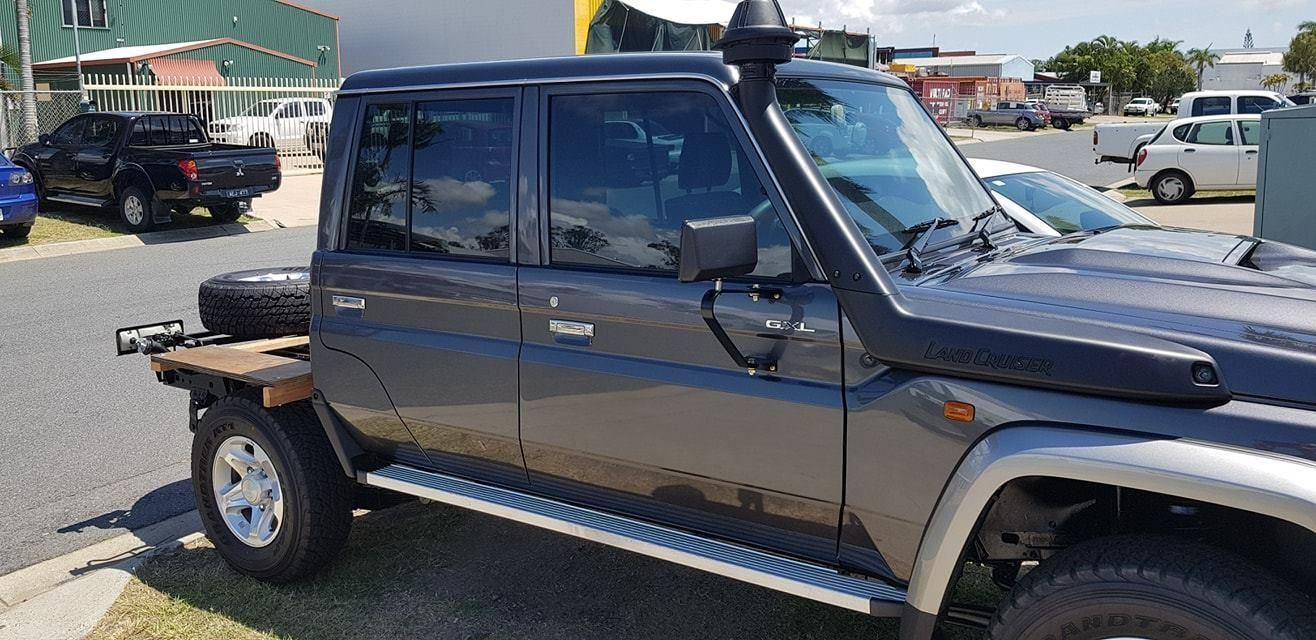 A Black Truck with a Snorkel on the Hood is Parked on the Side of the road β Epic Window Tinting in Glenella, QLD