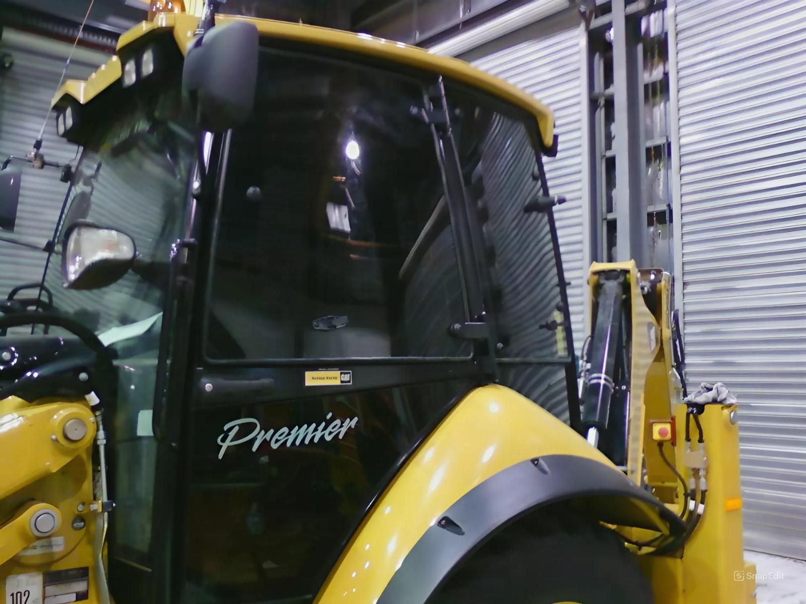 A Yellow Tractor with The Word Premier on It — Epic Window Tinting in Glenella, QLD