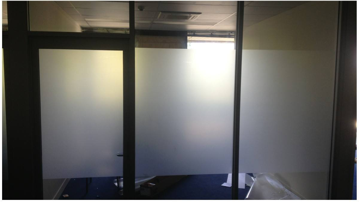 A Room with A Sliding Glass Door and Frosted Glass Walls — Epic Window Tinting in Mackay, QLD