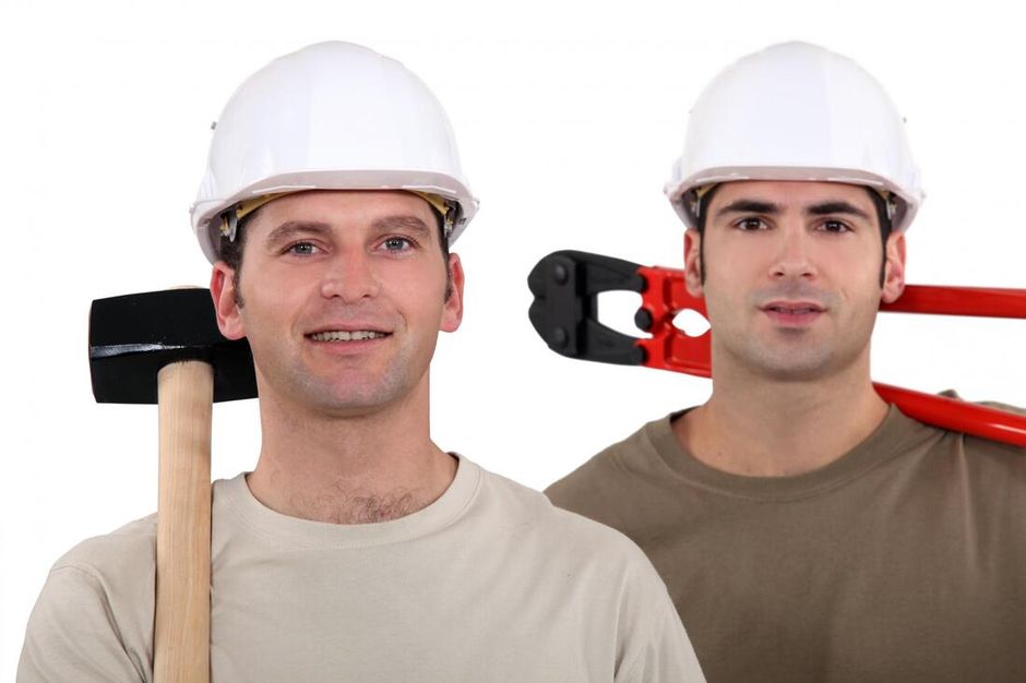 Picture of two construction workers with tools