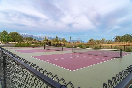 Black PVC chain mesh fence surrounding a tennis court