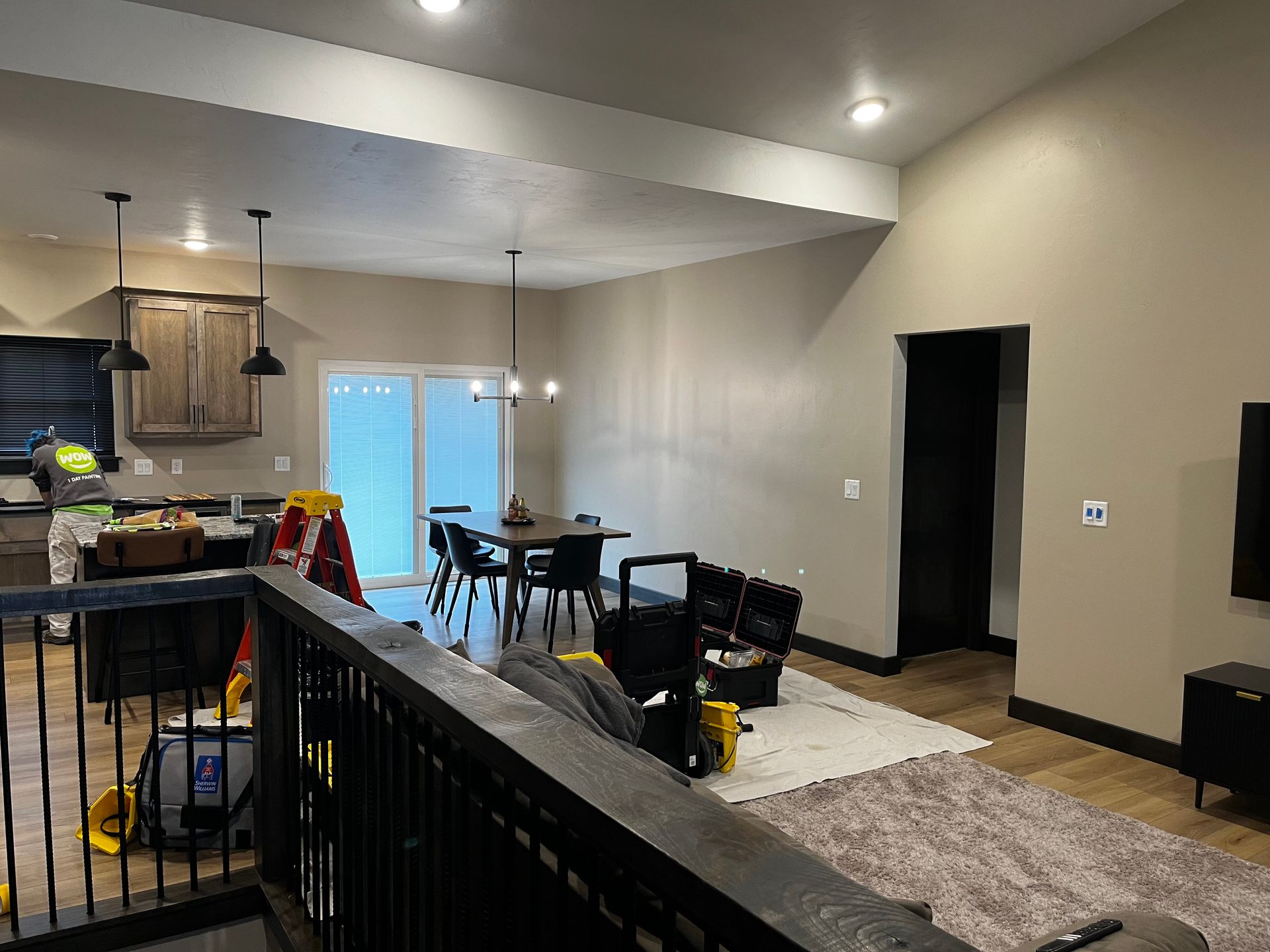 A living room with a couch , chairs , a table and a television.