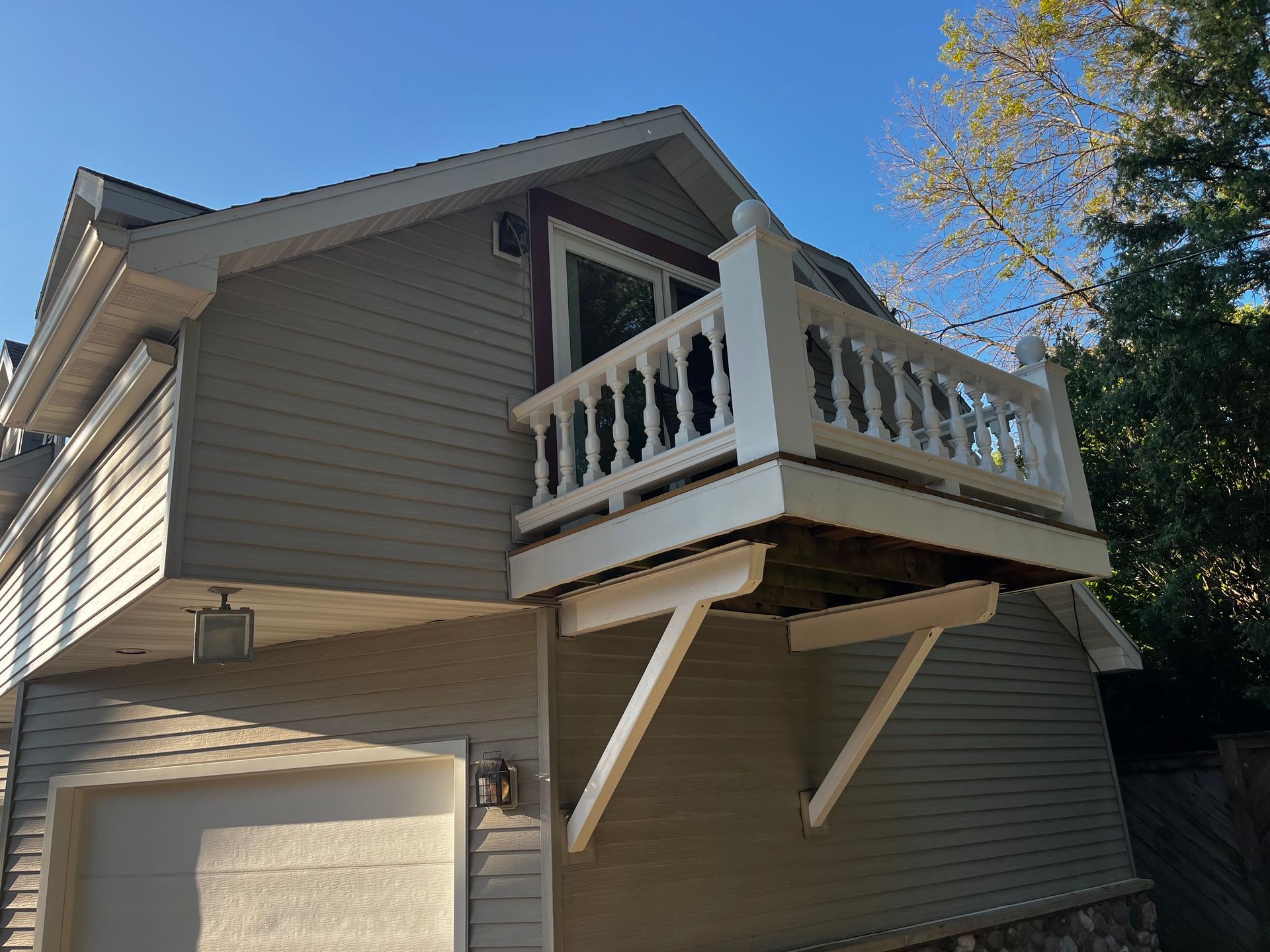 A house with a balcony on the side of it.