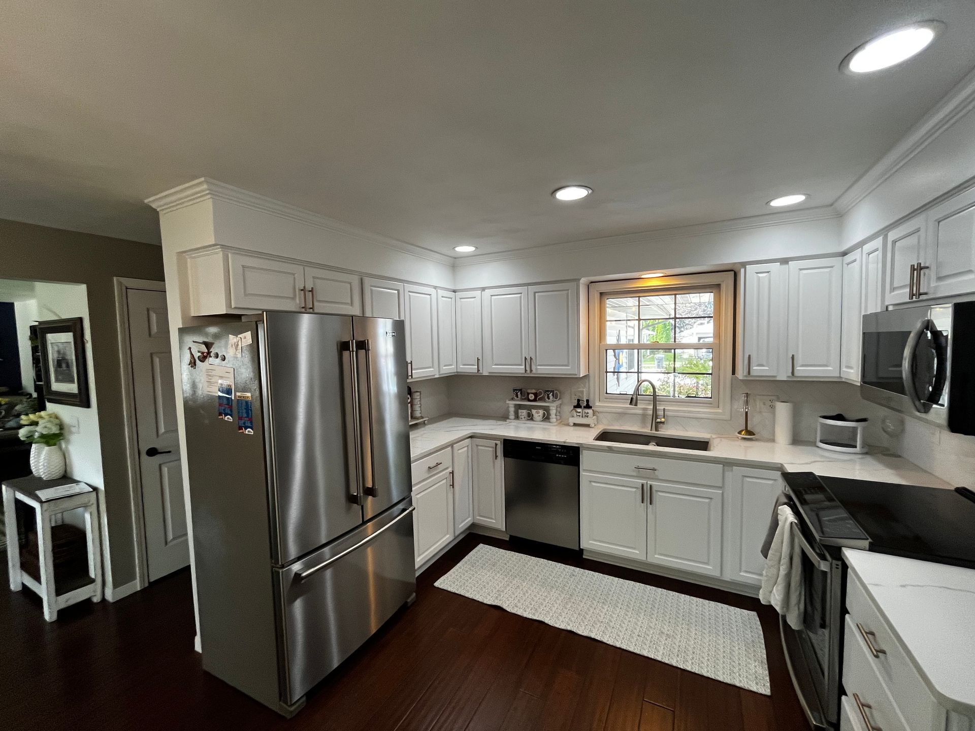A kitchen with white cabinets and stainless steel appliances.