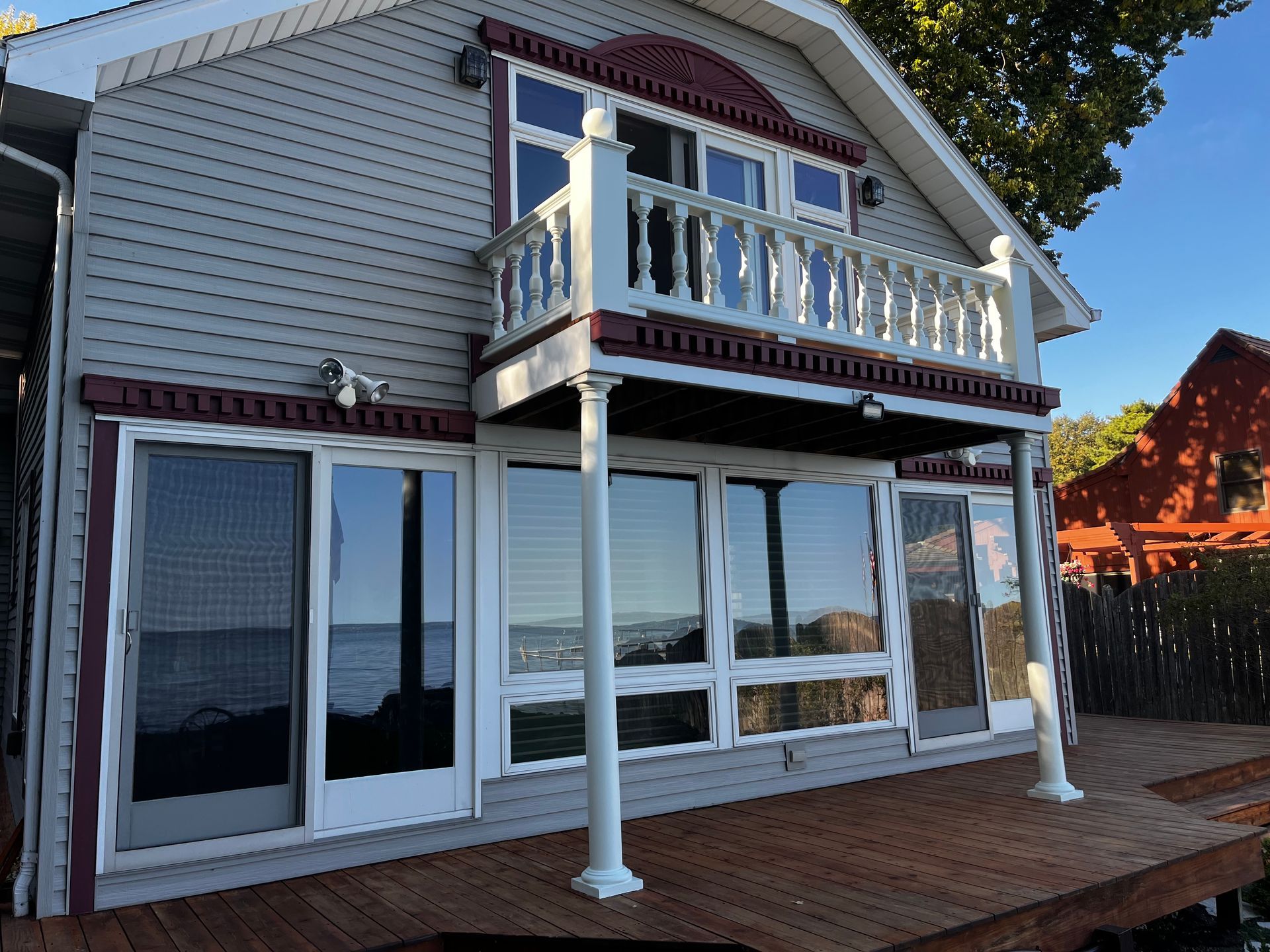 A house with a balcony overlooking a body of water