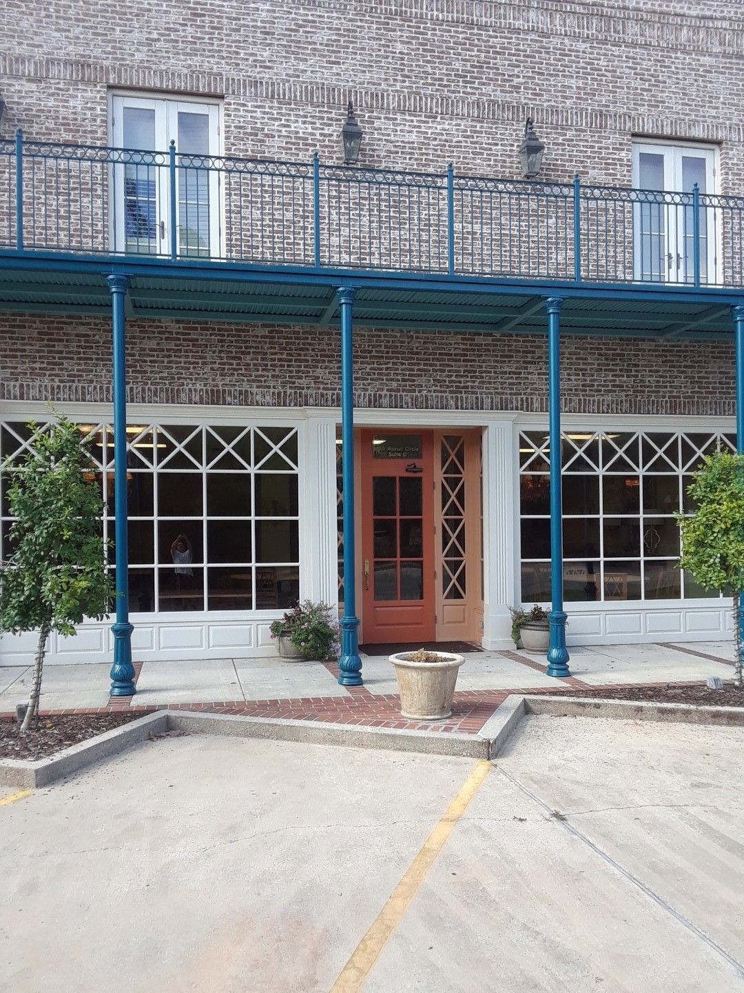 A brick building with a balcony and a door