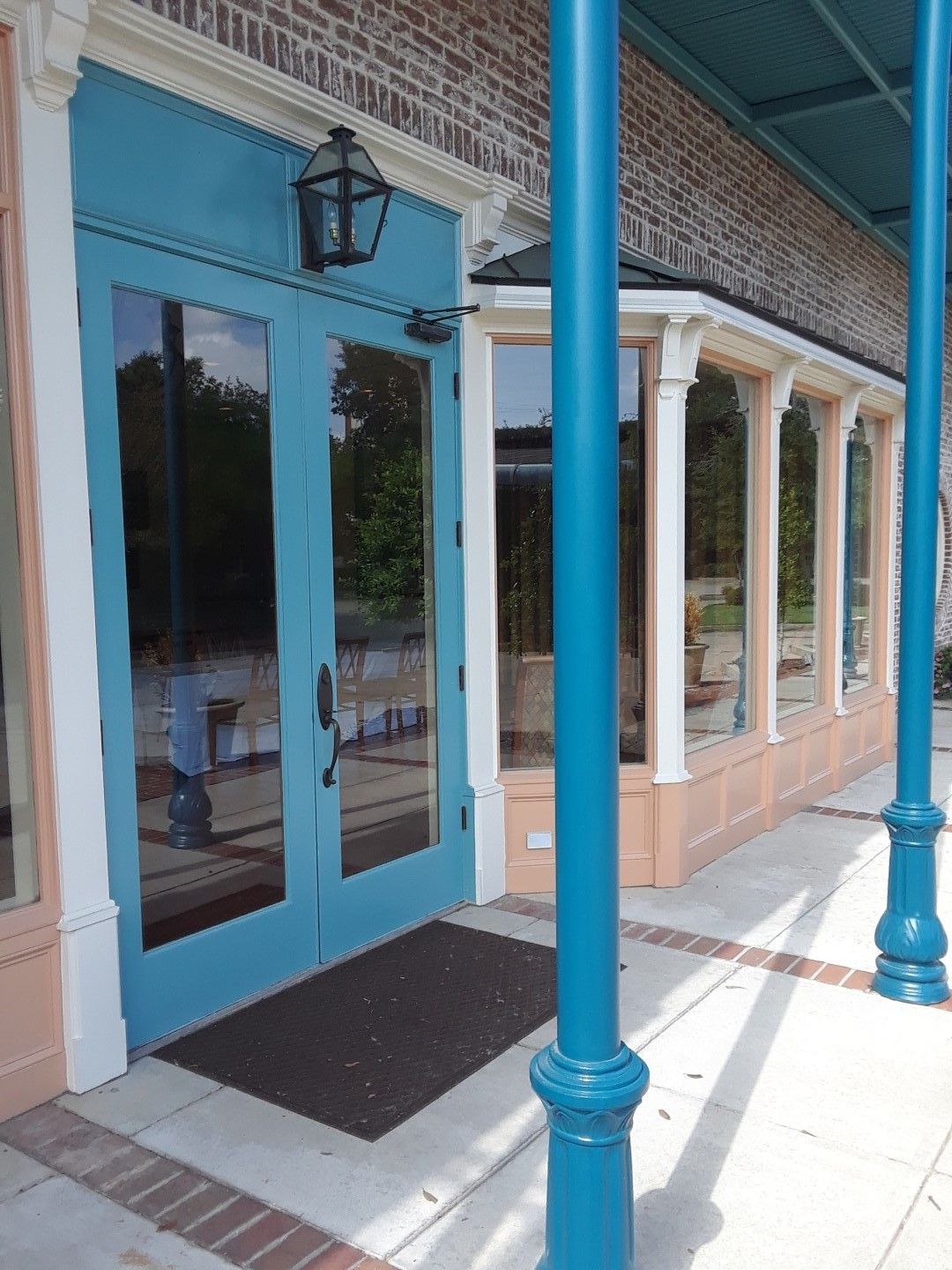 A blue door is on the side of a building