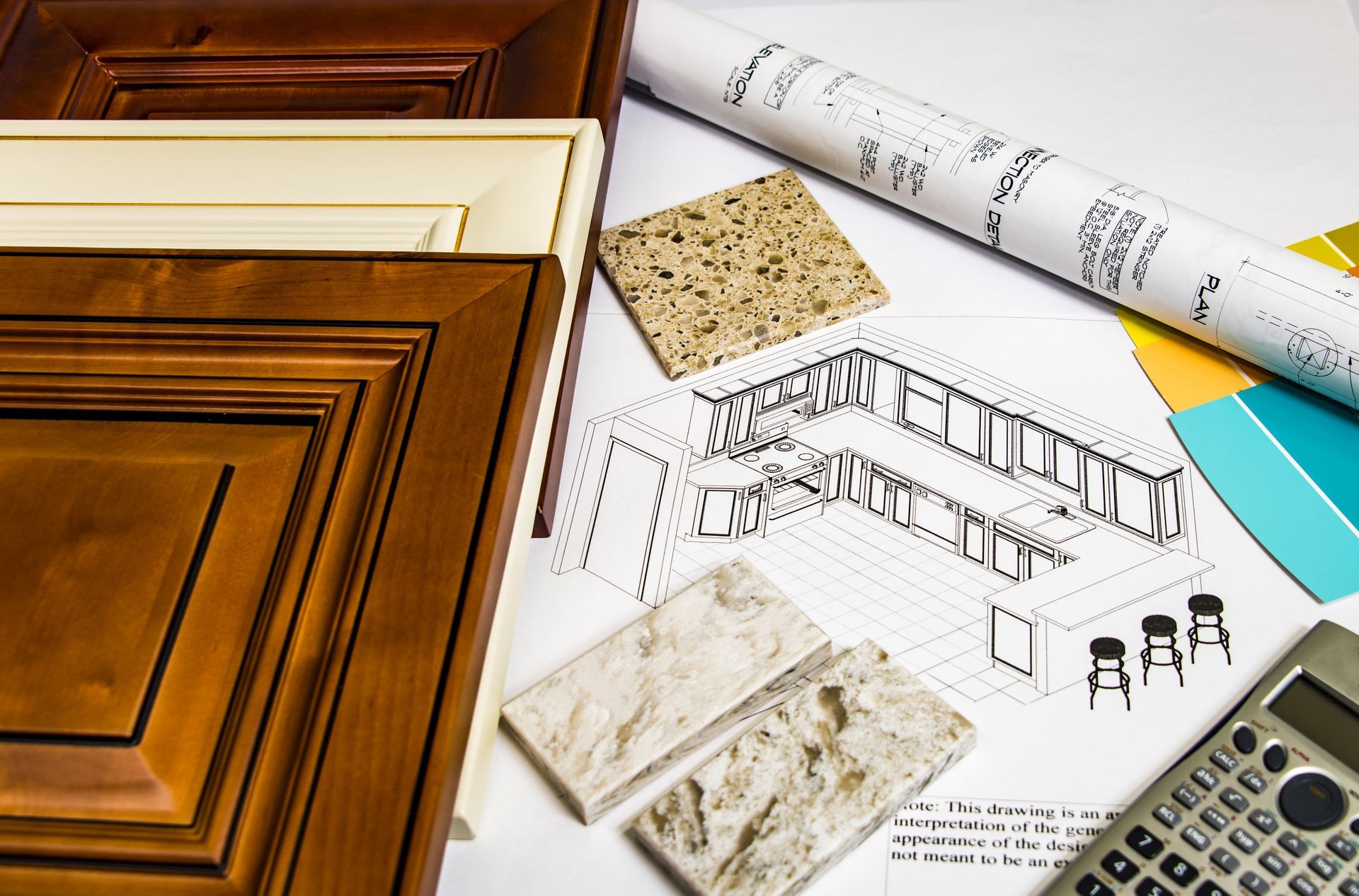 A calculator is sitting on a table next to a drawing of a house.