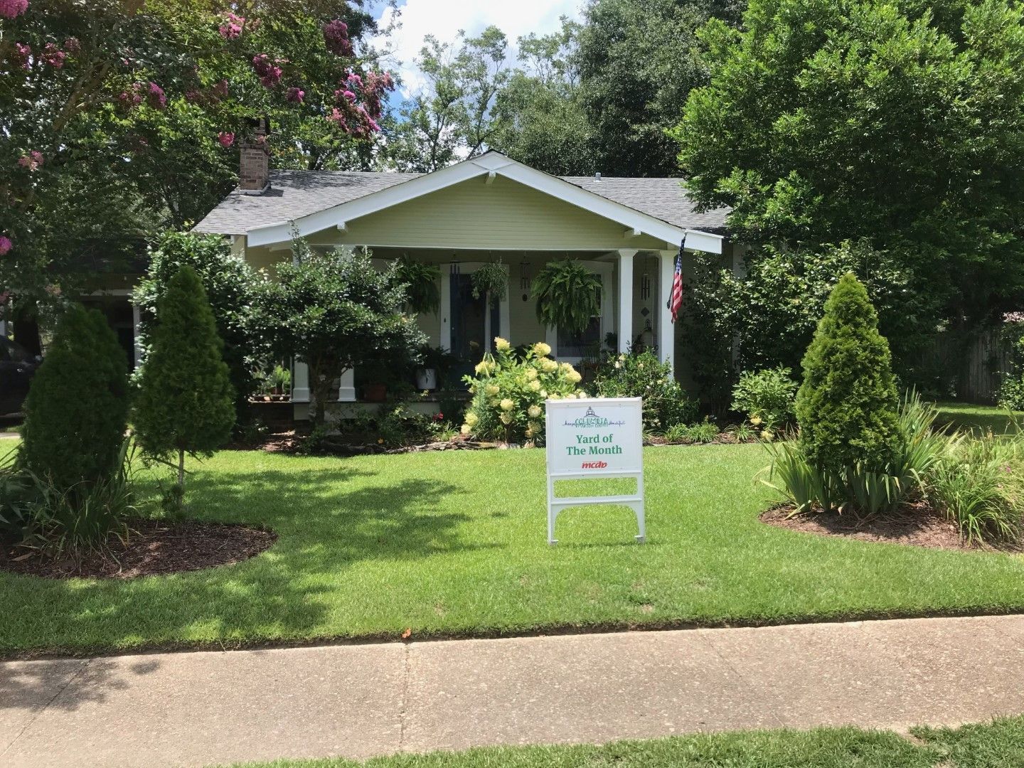 A house with a for sale sign in front of it
