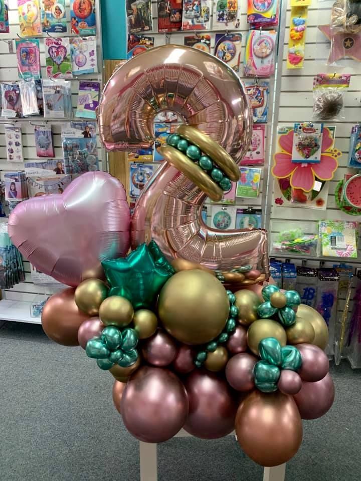 A Bunch of Balloons Are Sitting on A Table in A Store — Creative Events Innisfail in Tully, QLD  