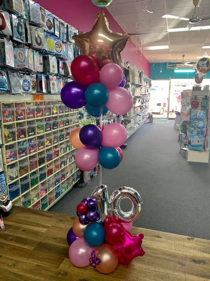 A Bunch of Balloons Are Sitting on A Table in A Store — Creative Events Innisfail in Mission Beach, QLD