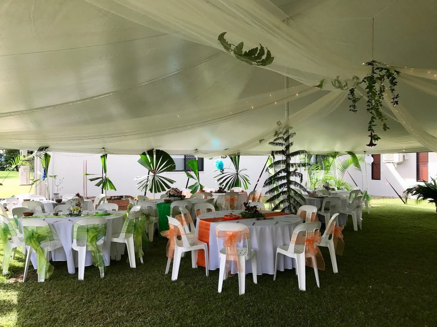 A Large White Tent with Tables and Chairs Underneath It — Creative Events Innisfail in Mission Beach, QLD