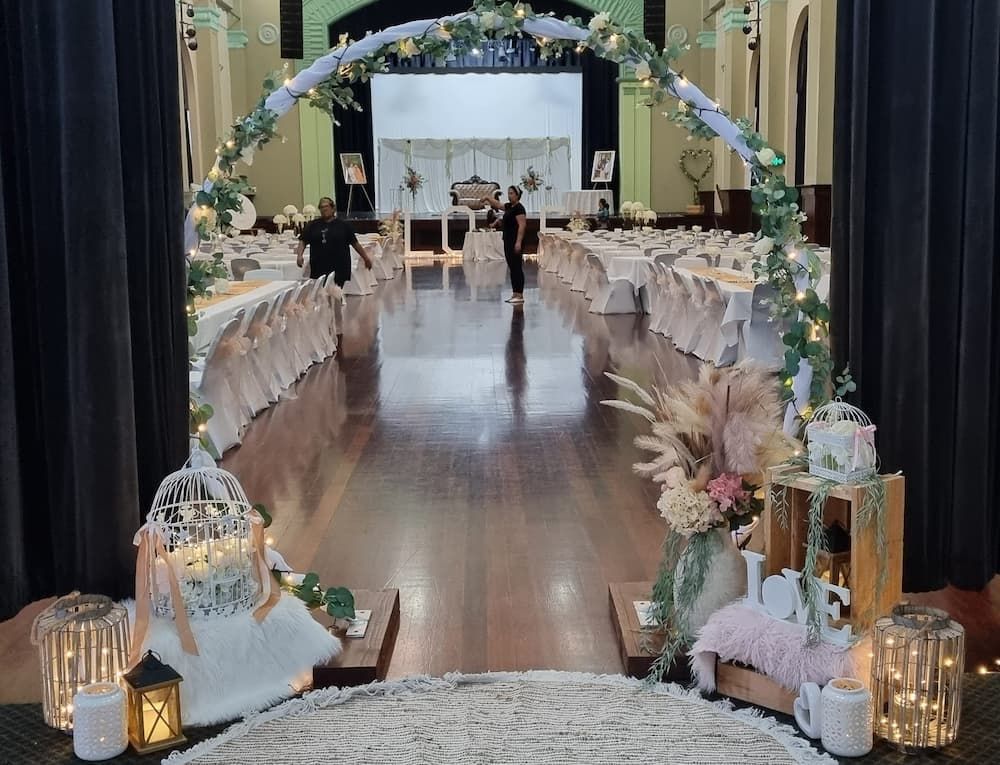 A Wedding Ceremony Is Taking Place in A Large Room with Tables and Chairs — Creative Events Innisfail in Innisfail, QLD
