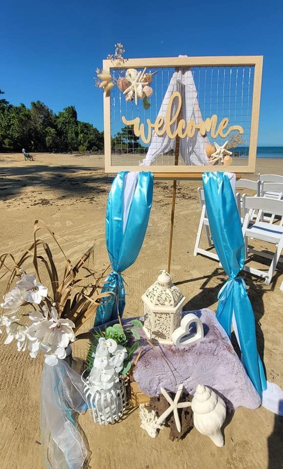 A Welcome Sign Is Sitting on Top of A Table on The Beach — Creative Events Innisfail in Innisfail, QLD