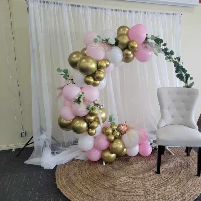 A Room with Pink and Gold Balloons and A Chair — Creative Events Innisfail in Tully, QLD  