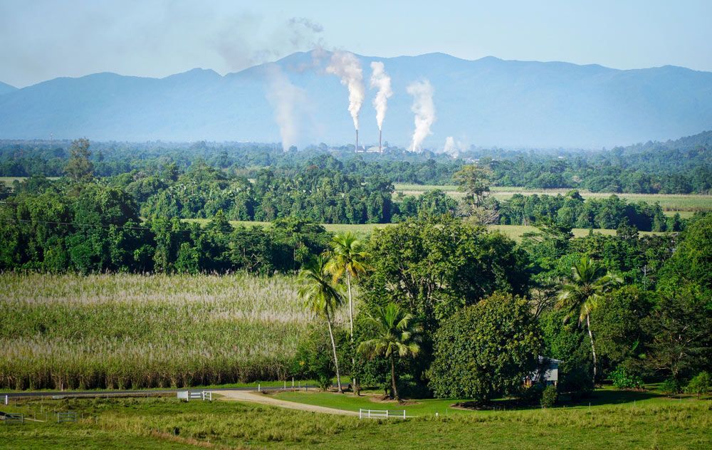 There Is a Factory in The Distance with Smoke Coming out Of It — Creative Events Innisfail in Tully, QLD