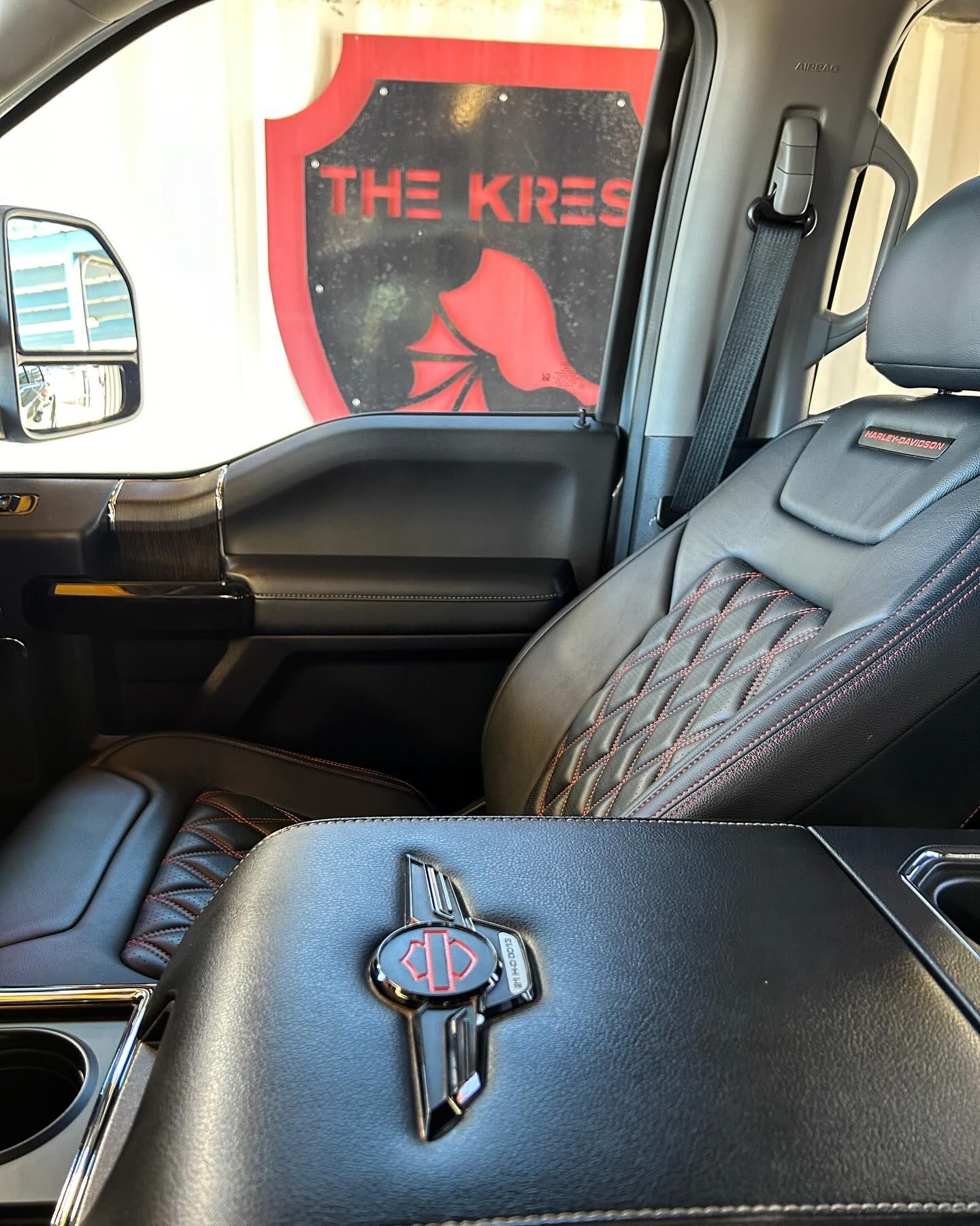 A close up of a car seat with a cross on it