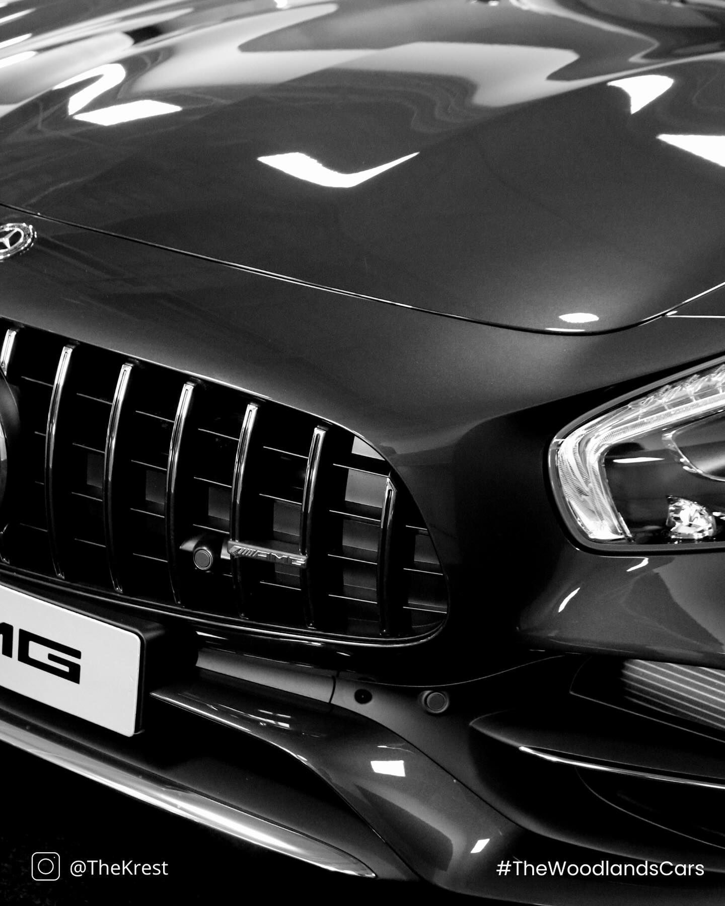 A black and white photo of a mercedes amg car