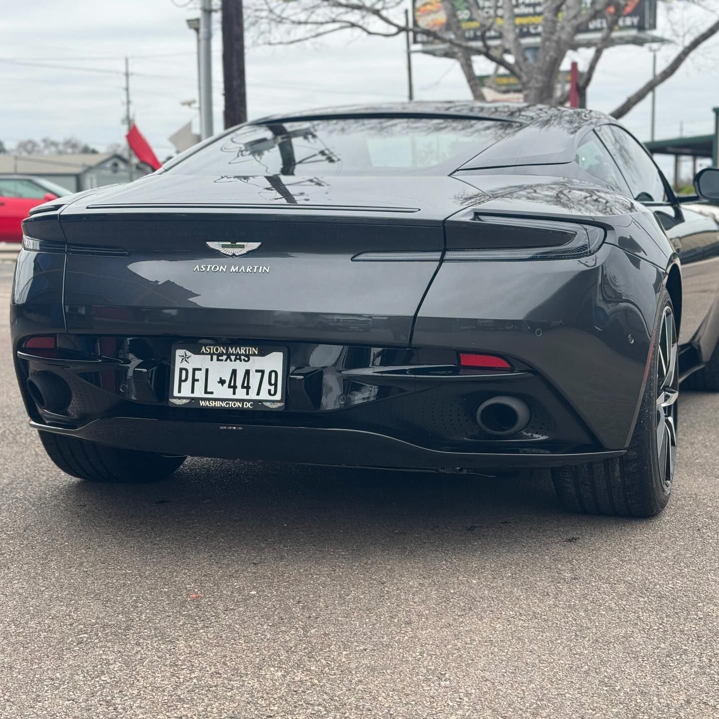 A black sports car with a license plate that says pfl-4479