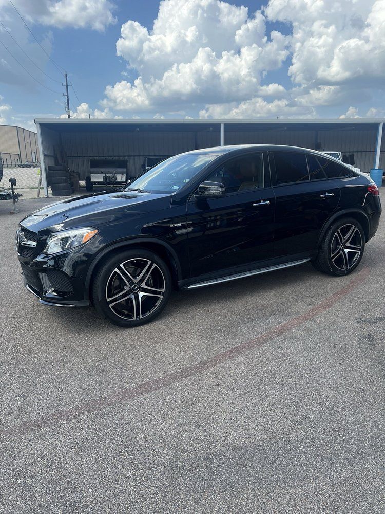A black mercedes benz gle 63 amg is parked in a parking lot.
