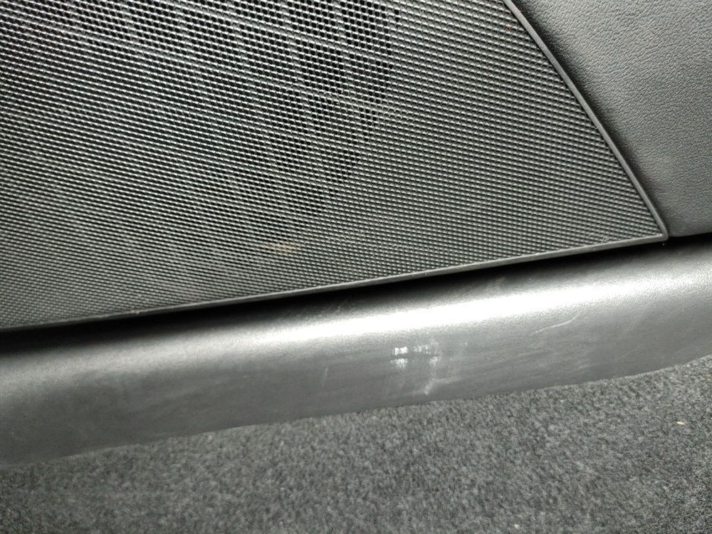 A close up of a speaker on the side of a car.