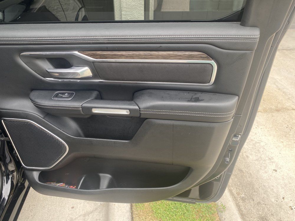 A close up of a car door with the door open.