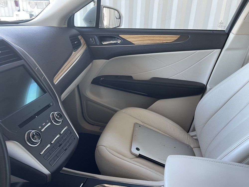 A car with a tablet in the back seat