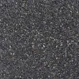 Close-up of a dark gray, speckled surface with small, light-colored flecks throughout.