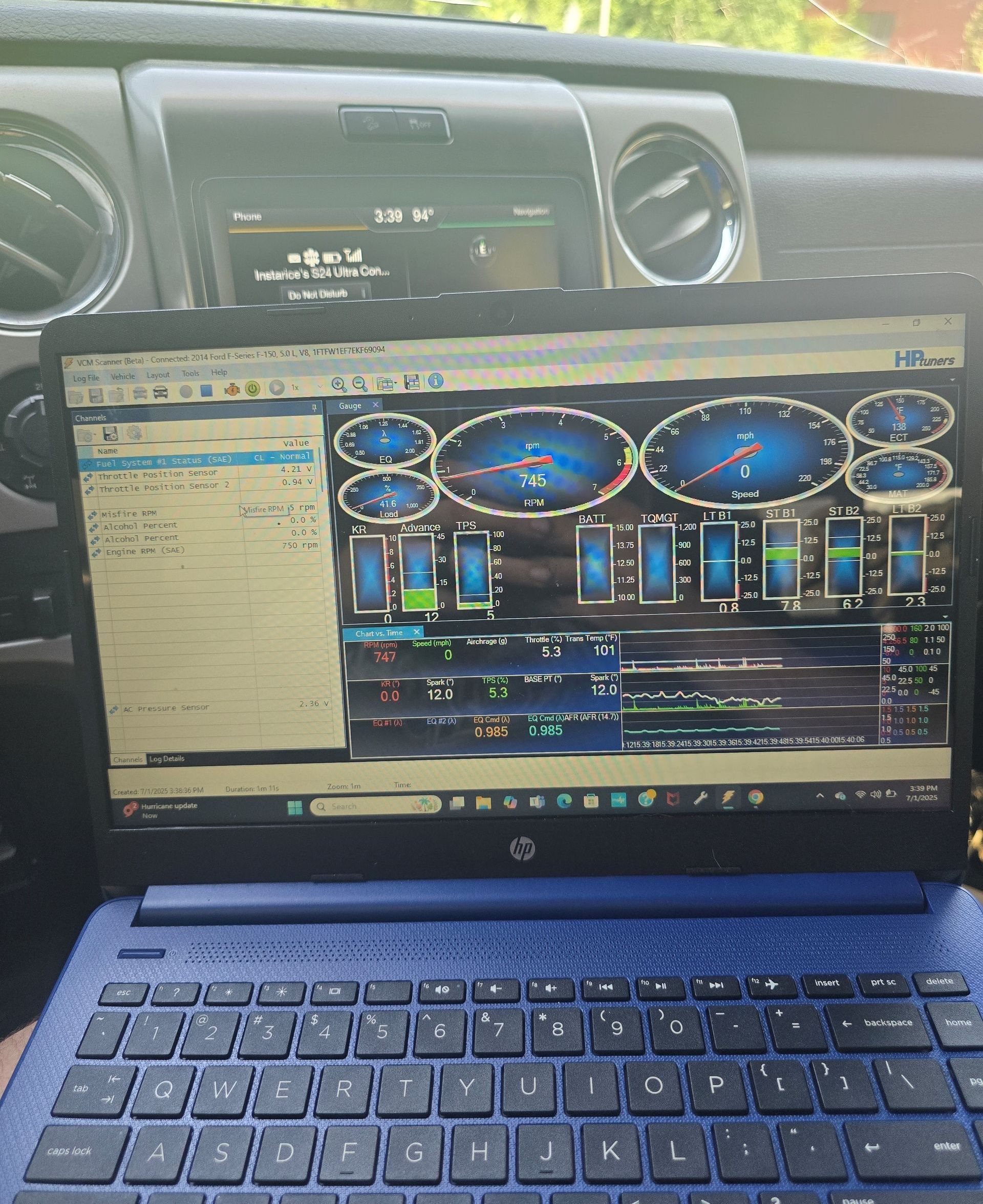 A close up of a car engine with the hood open.