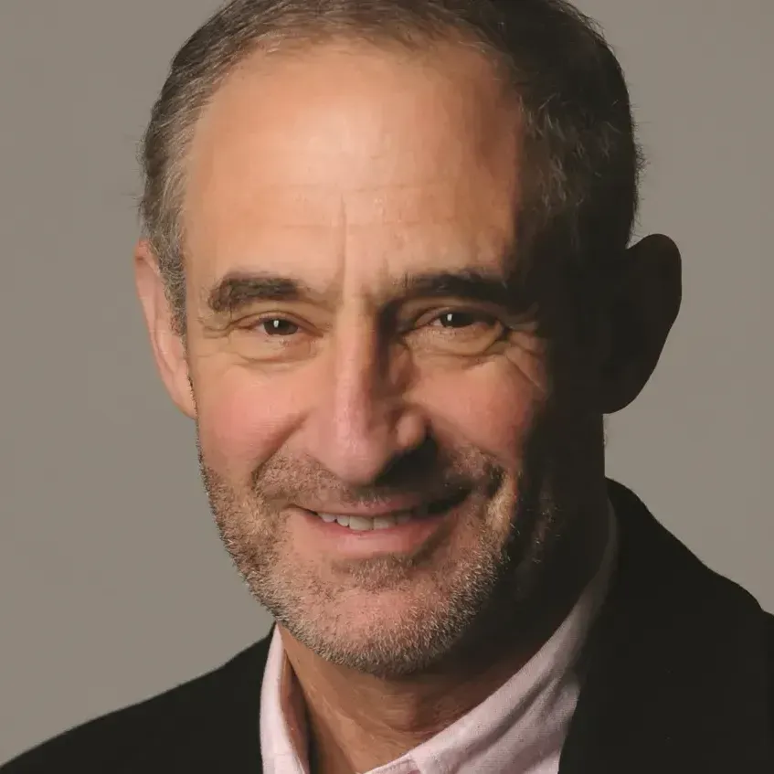 A man with a beard is smiling for the camera